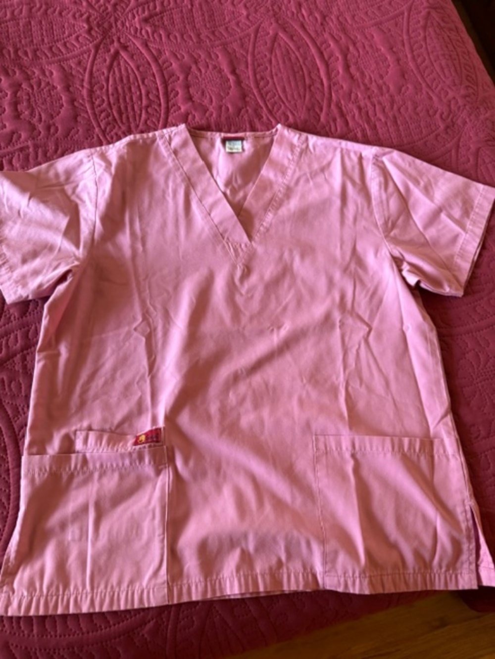 Rose colored scrub top/ size small, pockets in front